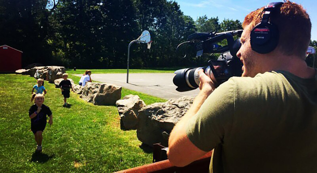 Ken Spooner films Layla with friends on a playground.