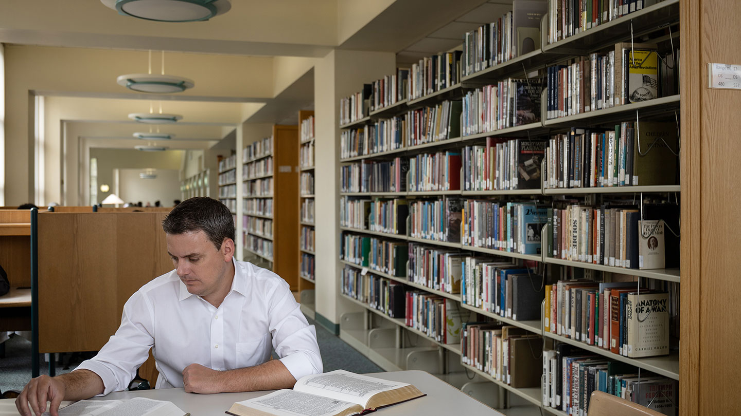 Jeffrey Miller reading in library