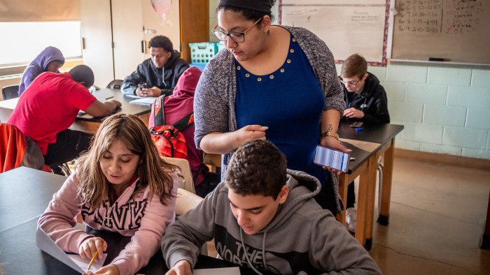 Teacher interacting with seated students