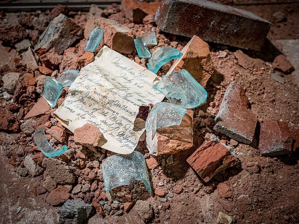 Letter surrounded by broken glass