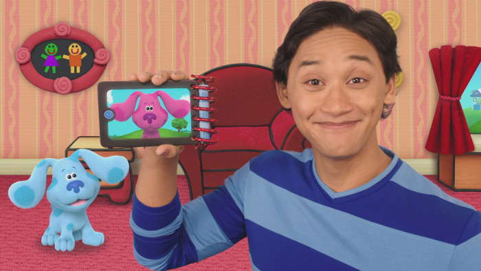Josh De La Cruz holding up device with Blues Clues on screen