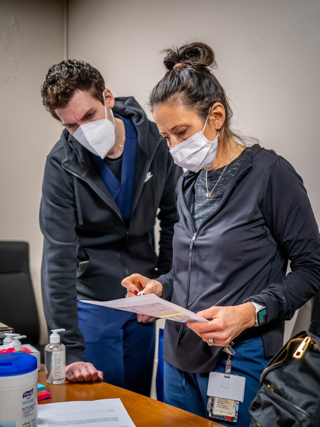 Theresa Migliaccio ’21 and Mark Rodrigues ’21, registered nurses who graduated this spring with the BSN degree, prepared necessary documentation for vaccine administration. “It’s exceptionally rewarding,” Rodrigues says, “knowing we are putting people on track for getting back some sort of normalcy.” Adds Migliaccio, “They cry and they’re so thankful.”