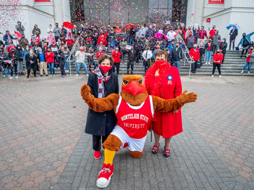 From left, President Susan A. Cole, Rocky and Karen L. Pennington in front of the masked crowd at Pennington’s send-off.