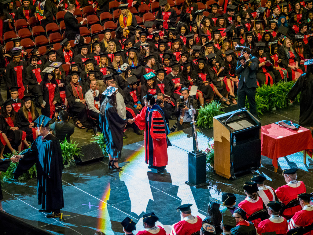 Cole congratulates a graduate, one of about 100,000 students who graduated from Montclair State during her tenure.