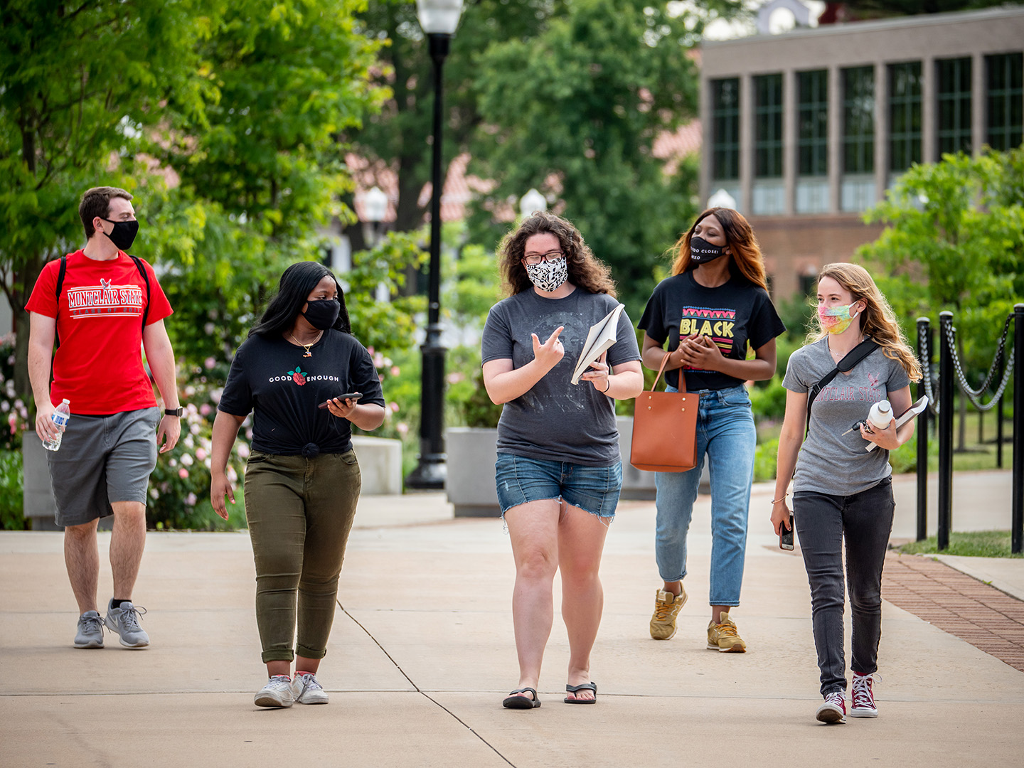 five students walking on campus