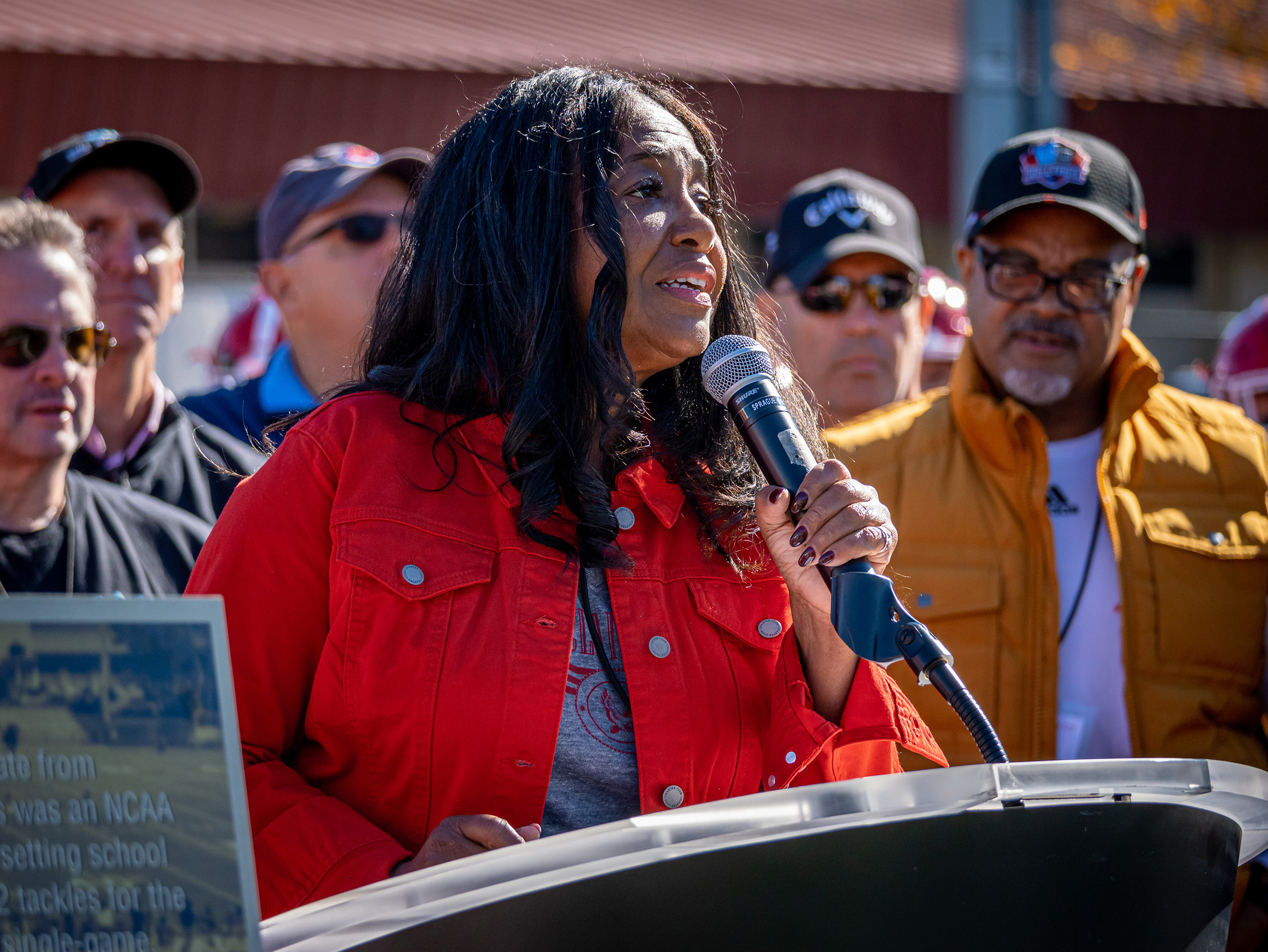 Melanie Mills speaking at podium