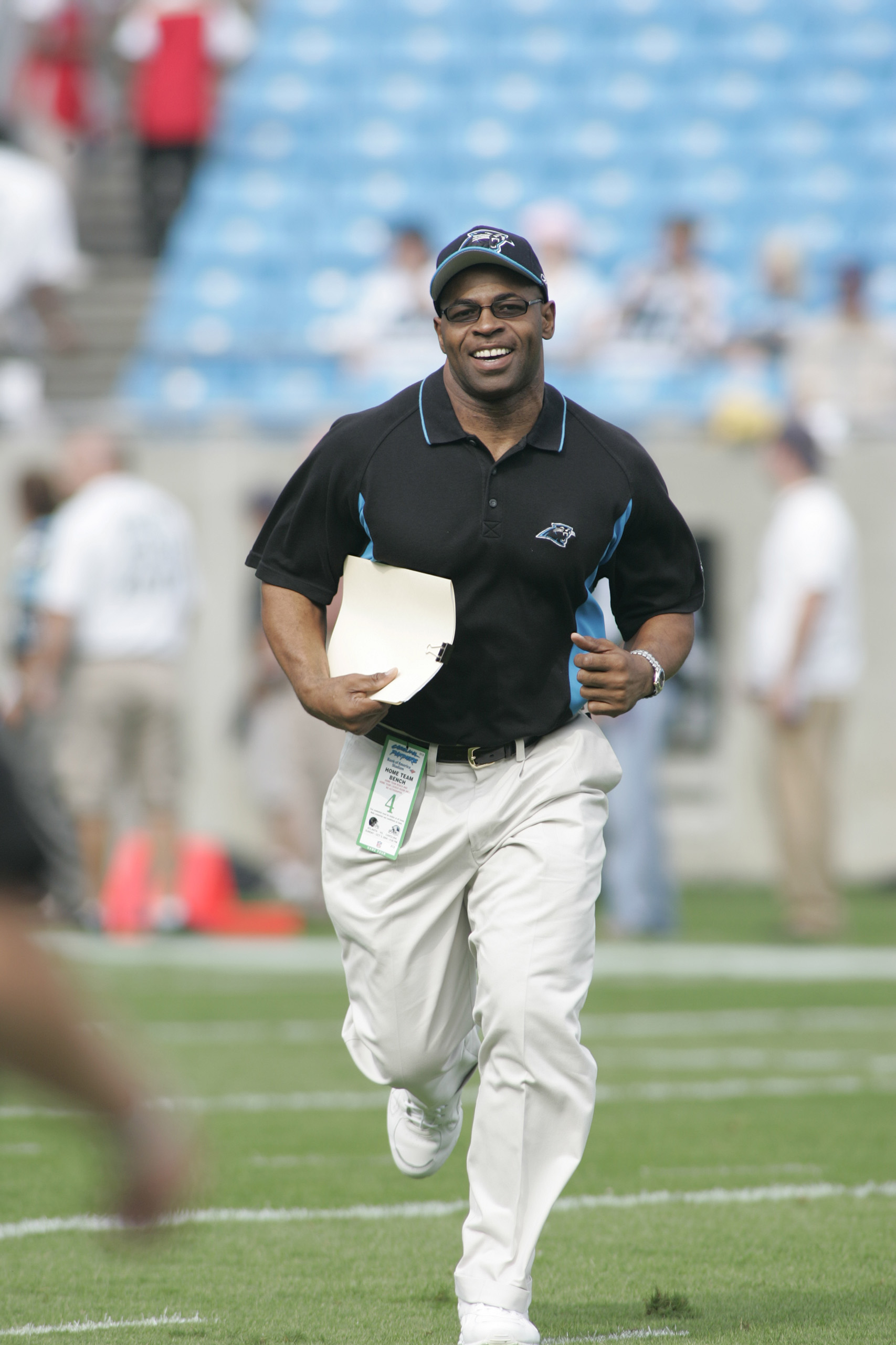 Sam Mills running with clipboard in hand