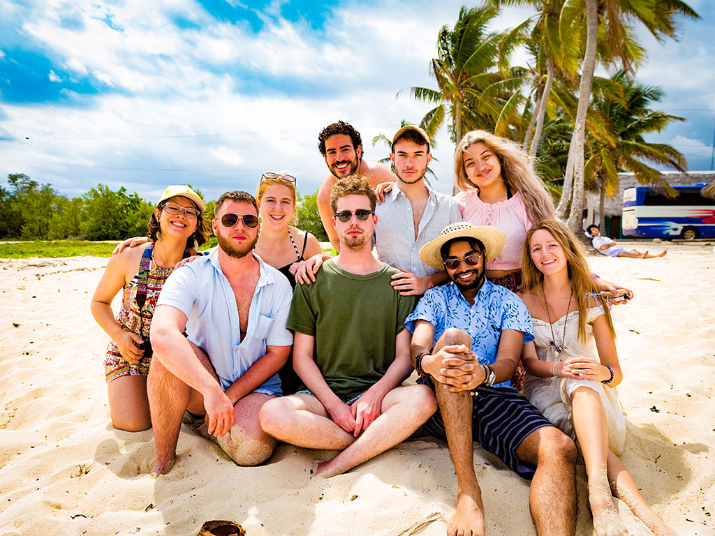 Montclair State University student filmmakers sitting on a beach in Cuba.
