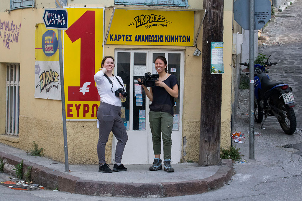 Students Allison Councill and Kristie Keleshian shoot video of street scenes in Mytilene on the island of Lesbos.