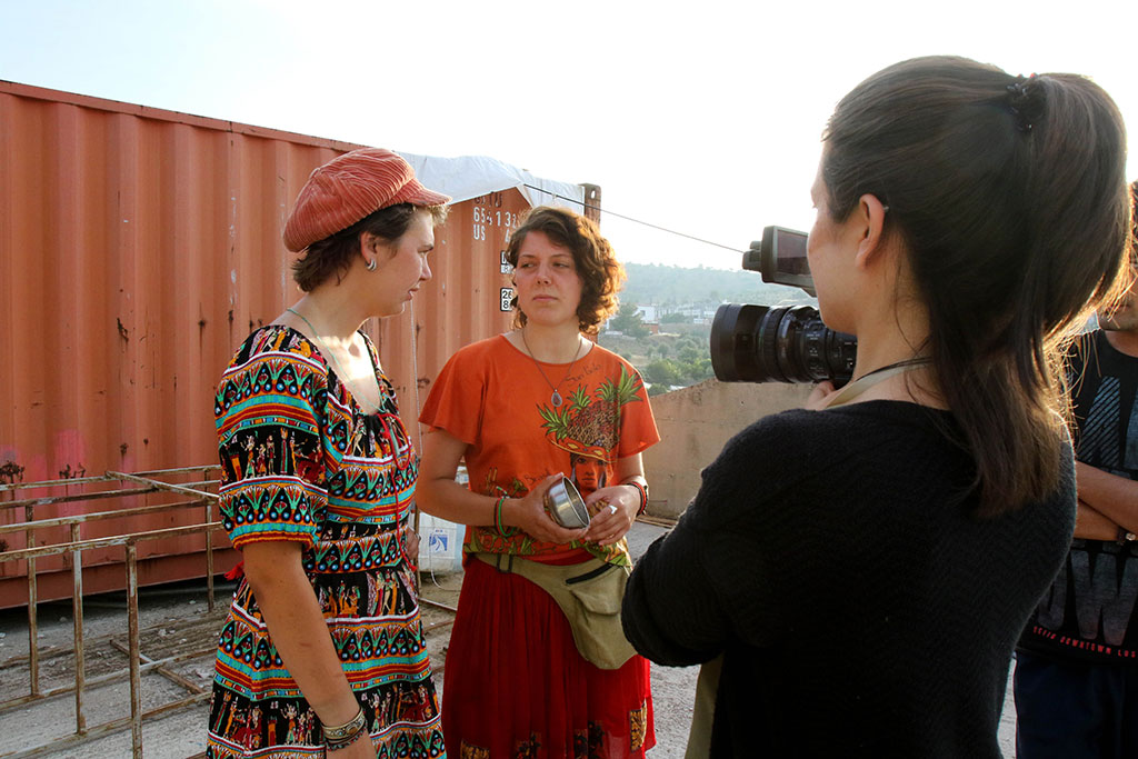 Student Kristie Keleshian interviews films volunteers at a refugee community center in an abandoned industrial building near the Kara Tepe camp.