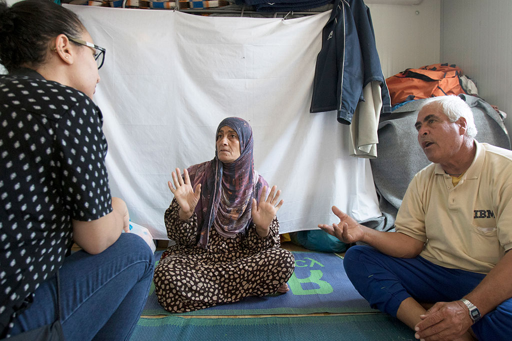 Nadia Abbas interviews a Syrian refugee family in Arabic inside their trailer at the Kara Tepe camp in Lesbos.