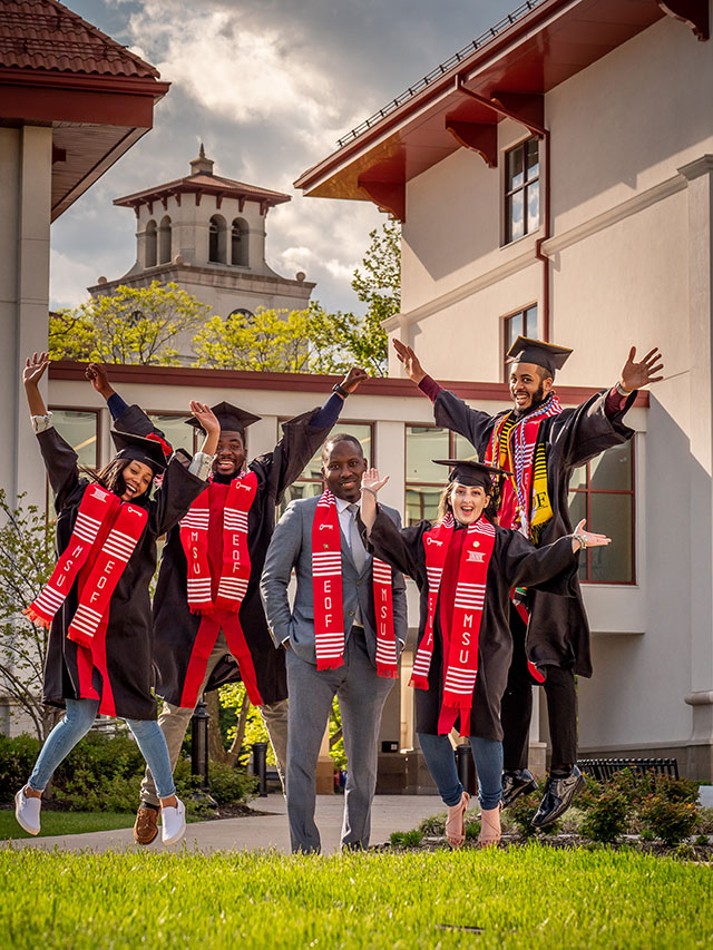 Executive Director Daniel Jean (center) with a few of the 2019 EOF Scholar graduates. Pictured left to right: Julia Barton, Christopher Philippe, Kassandra Ramos and Elijah Blackwell.