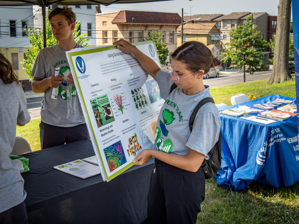 Interns bring their “green” message to communities, working a music festival in Newark to share infographics and interactive games.