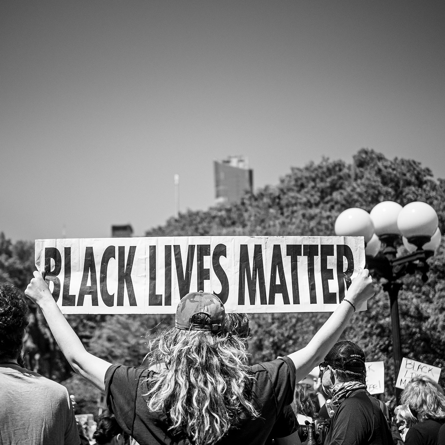 Female protestor holding up Black Lives Matter sign
