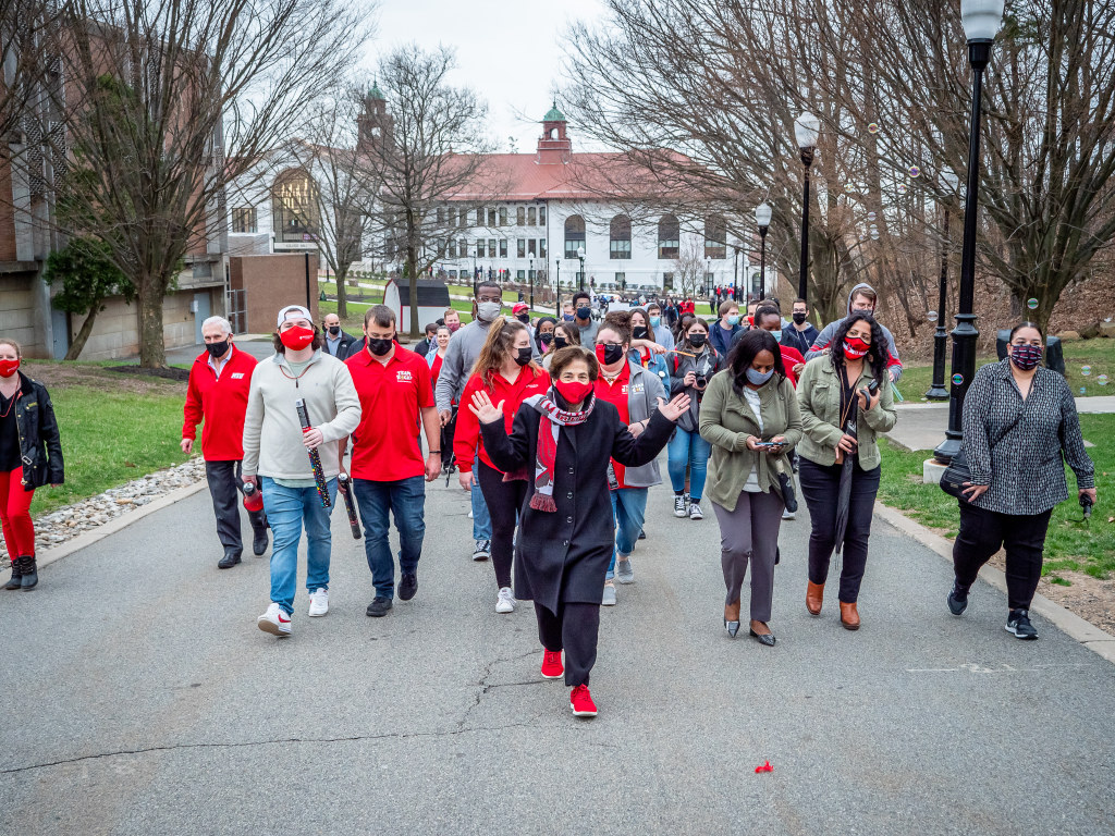Cole leads an on-campus parade of students, faculty and staff in spring 2021.