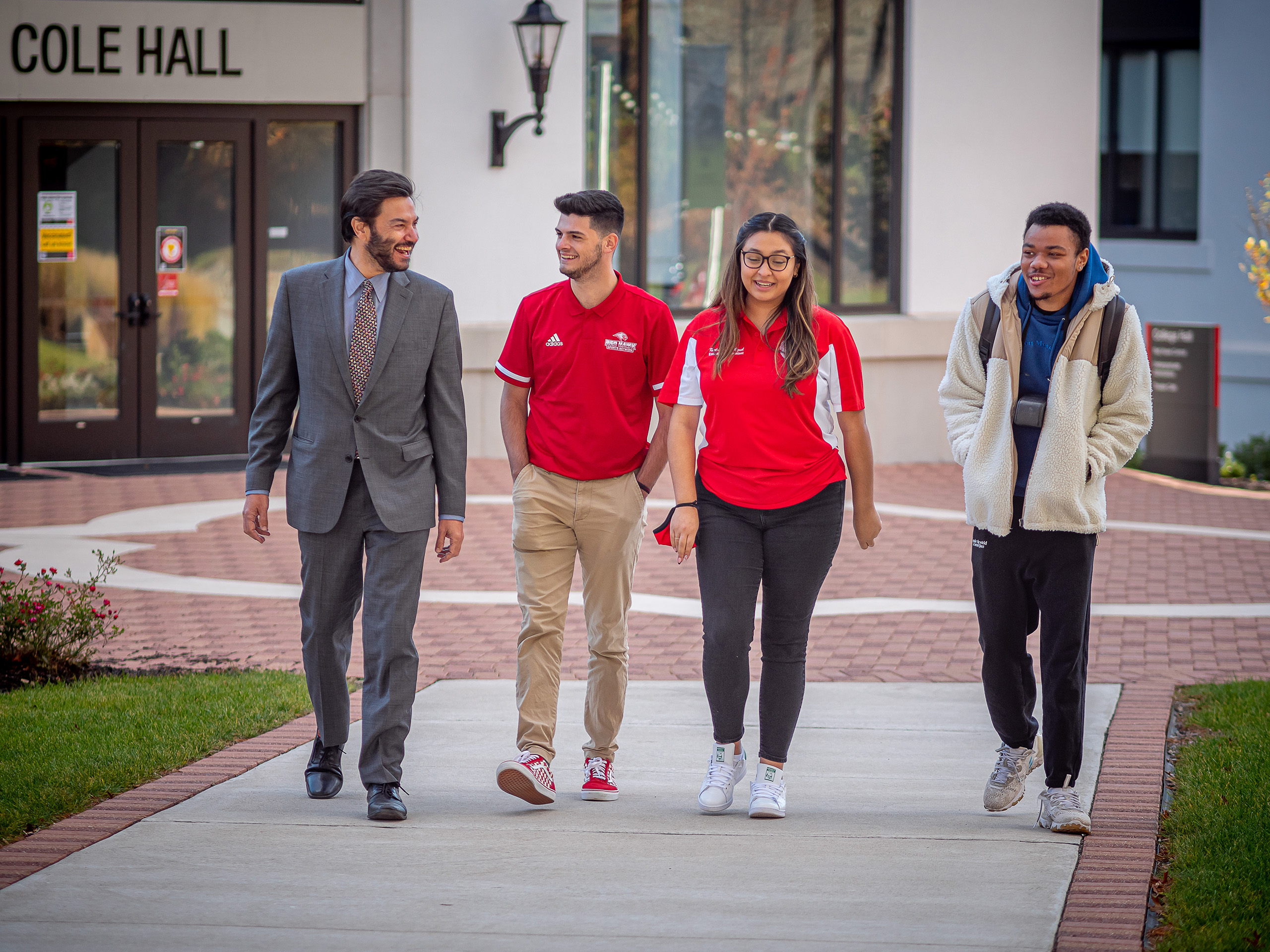 President Koppell walking with students on campus