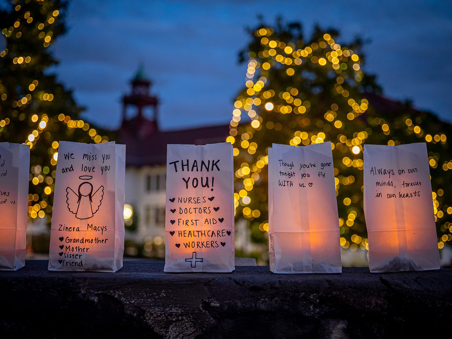 Lighted luminaria at dusk with messages by the MSU community