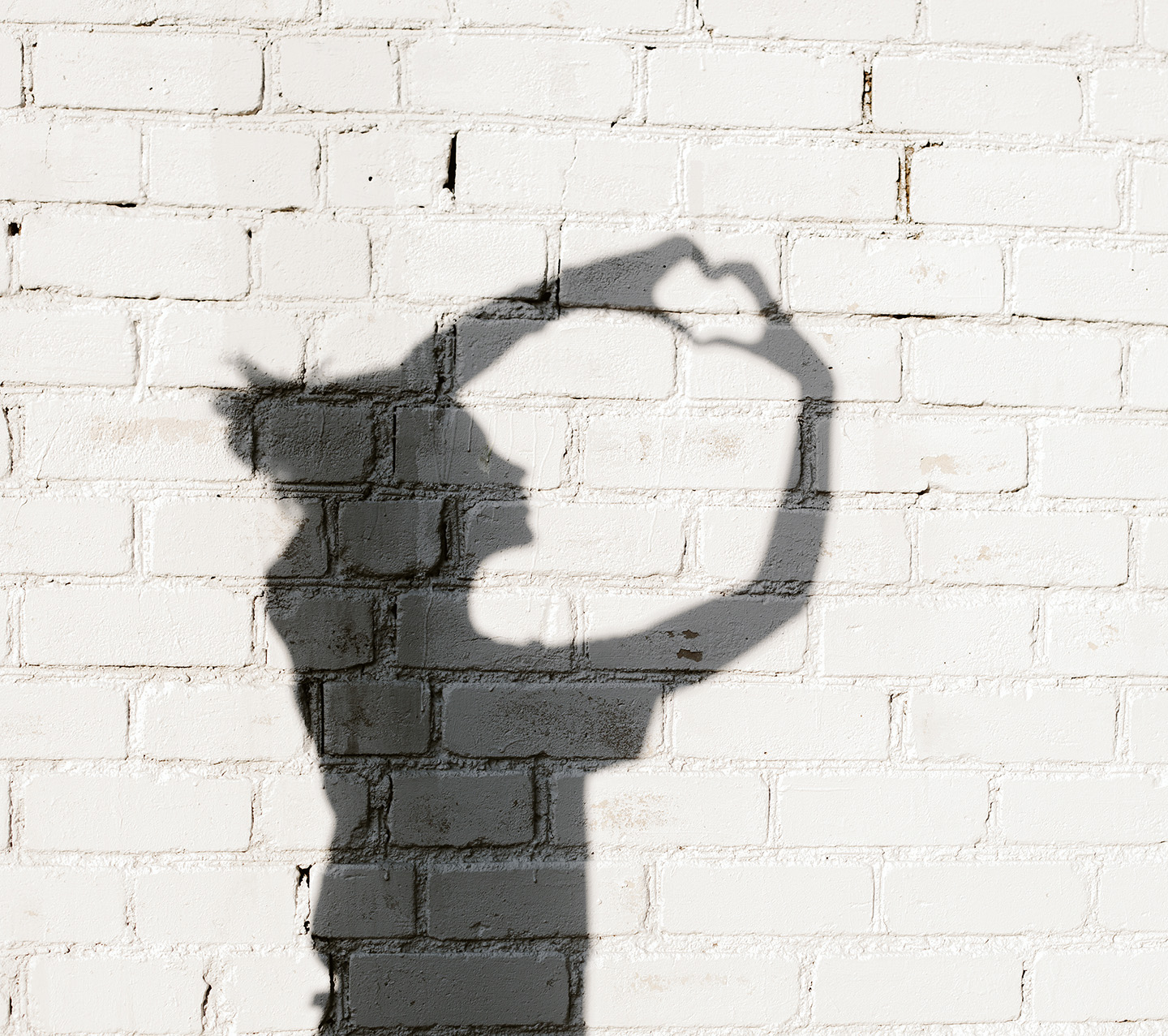 Photo of shadows of girl forming a heart with her hands