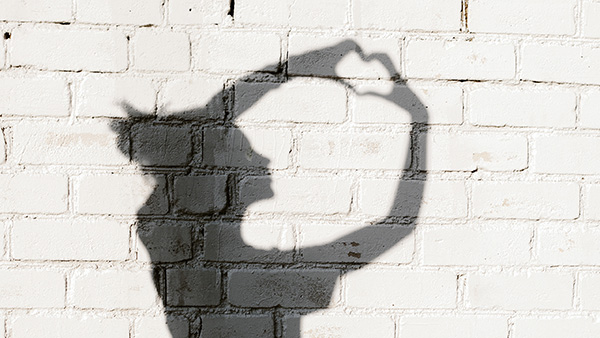 Photo of shadows of girl forming a heart with her hands