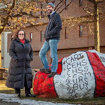 Julie Fleming and Anthony Mennuti pose with a painted rock