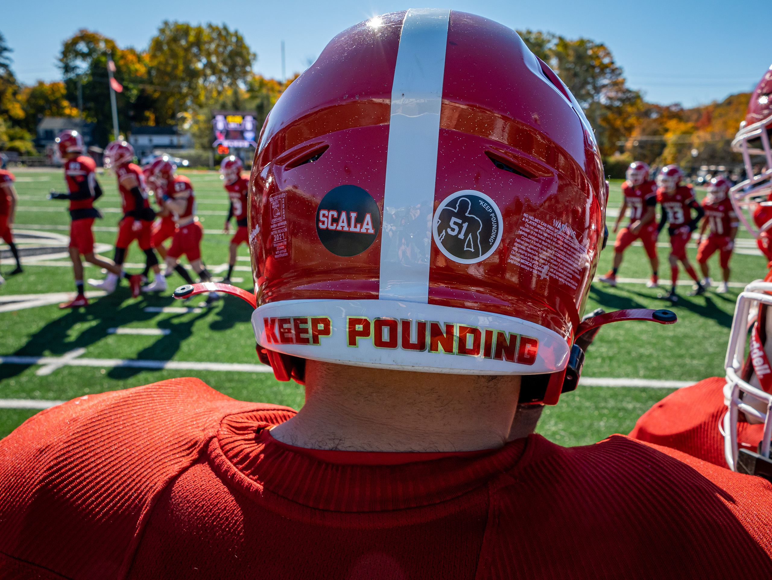 Photo of a the back of a Red Hawk's helmet with "Keep Pounding" printed along the bottom edge