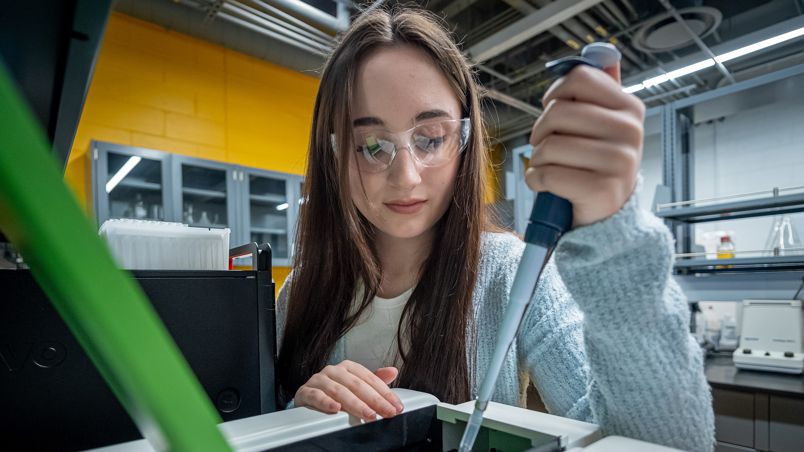 student wearing safety glasses in science lab