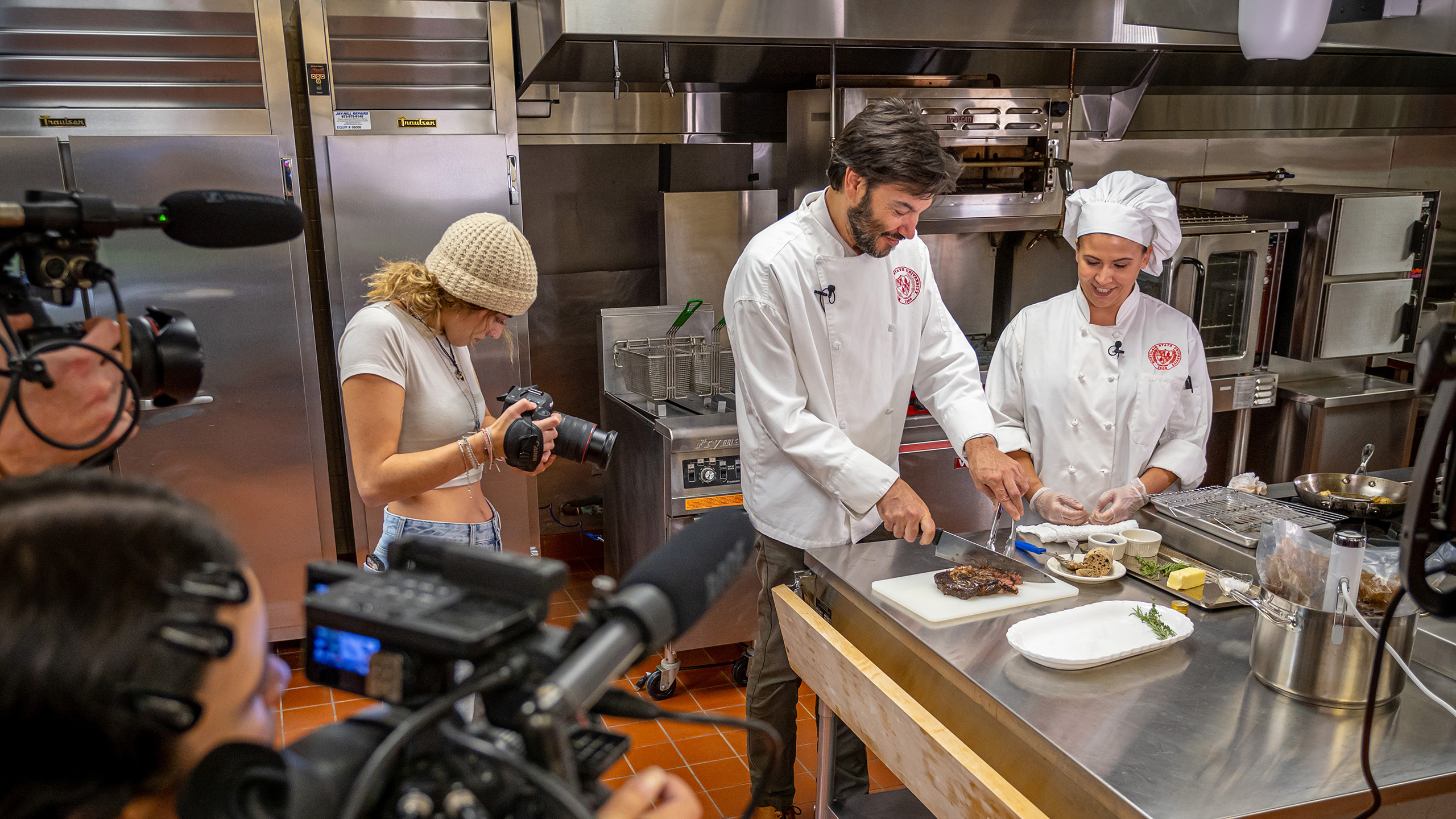 Montclair State University President Jonathan Koppell cooking at Sam's Diner