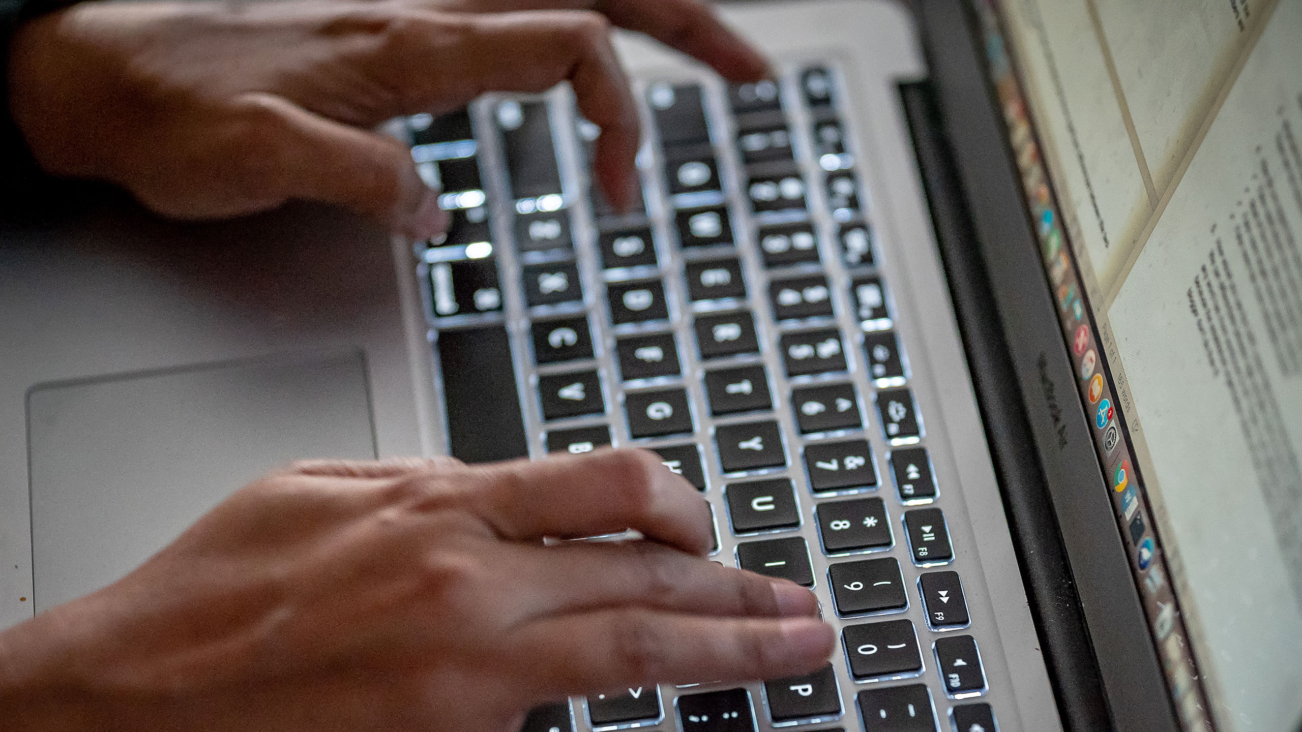 hands over a laptop keyboard