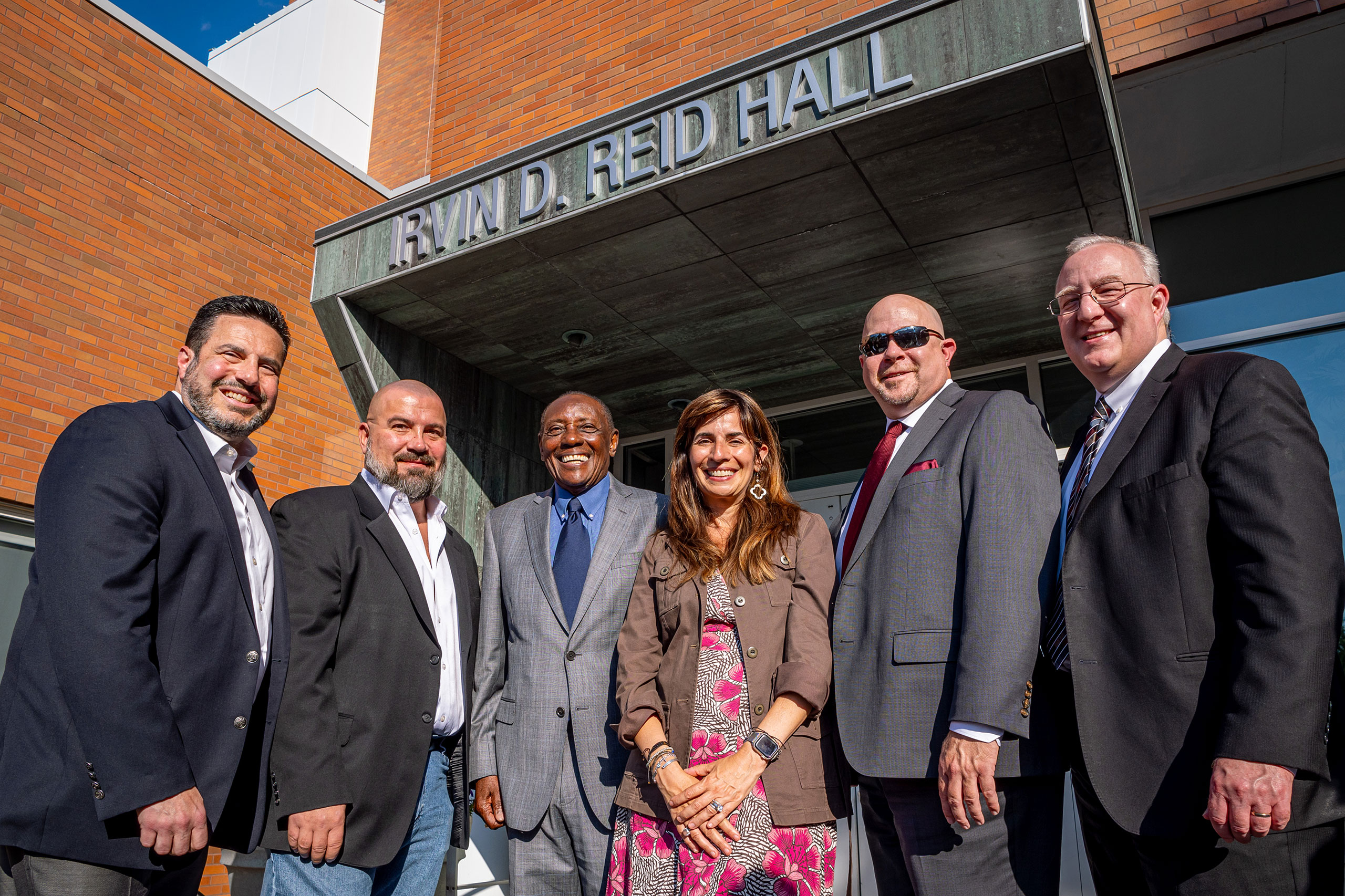 group poses in front of Reid Hall
