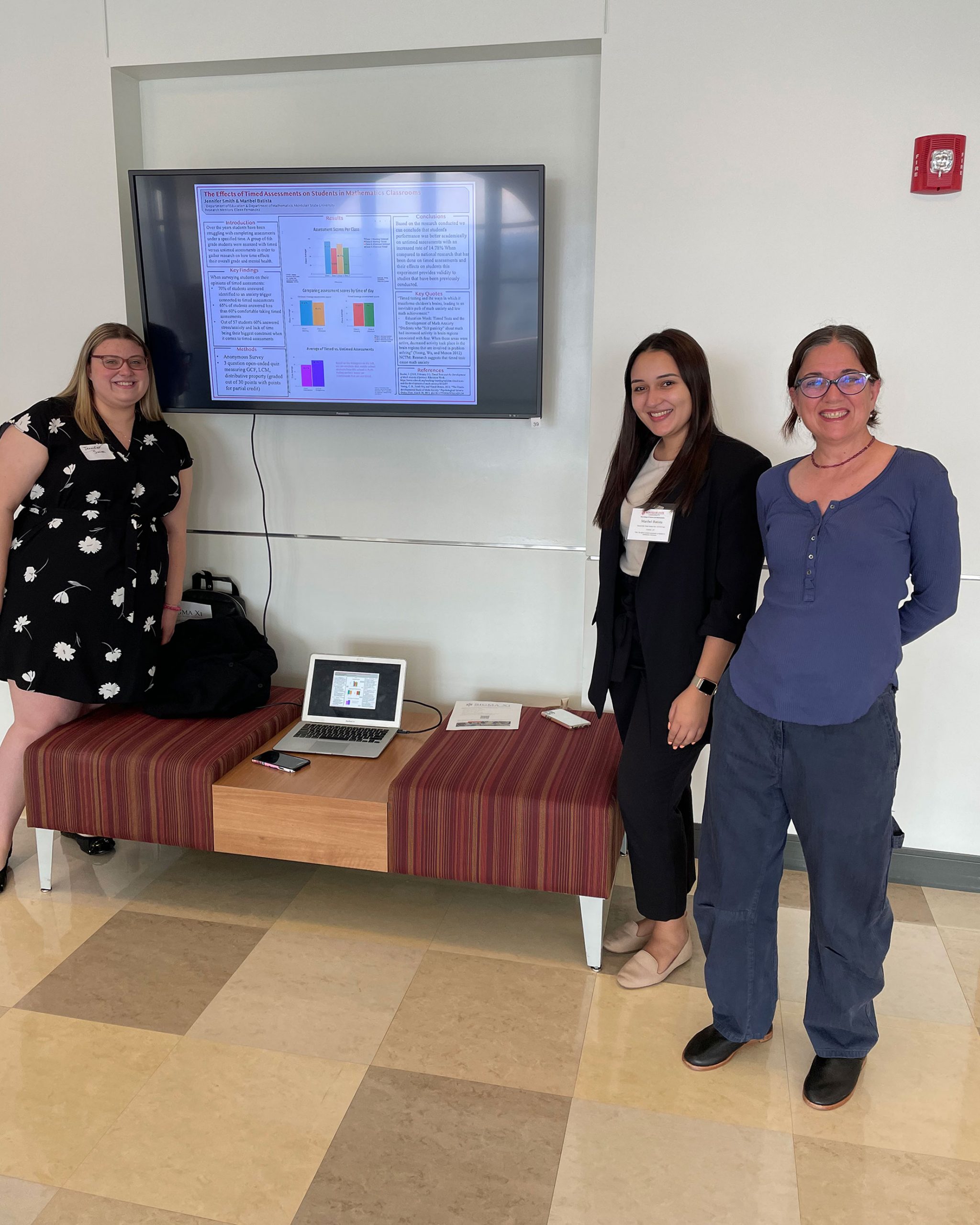 students with poster and their mentor, Dr. Fernandez