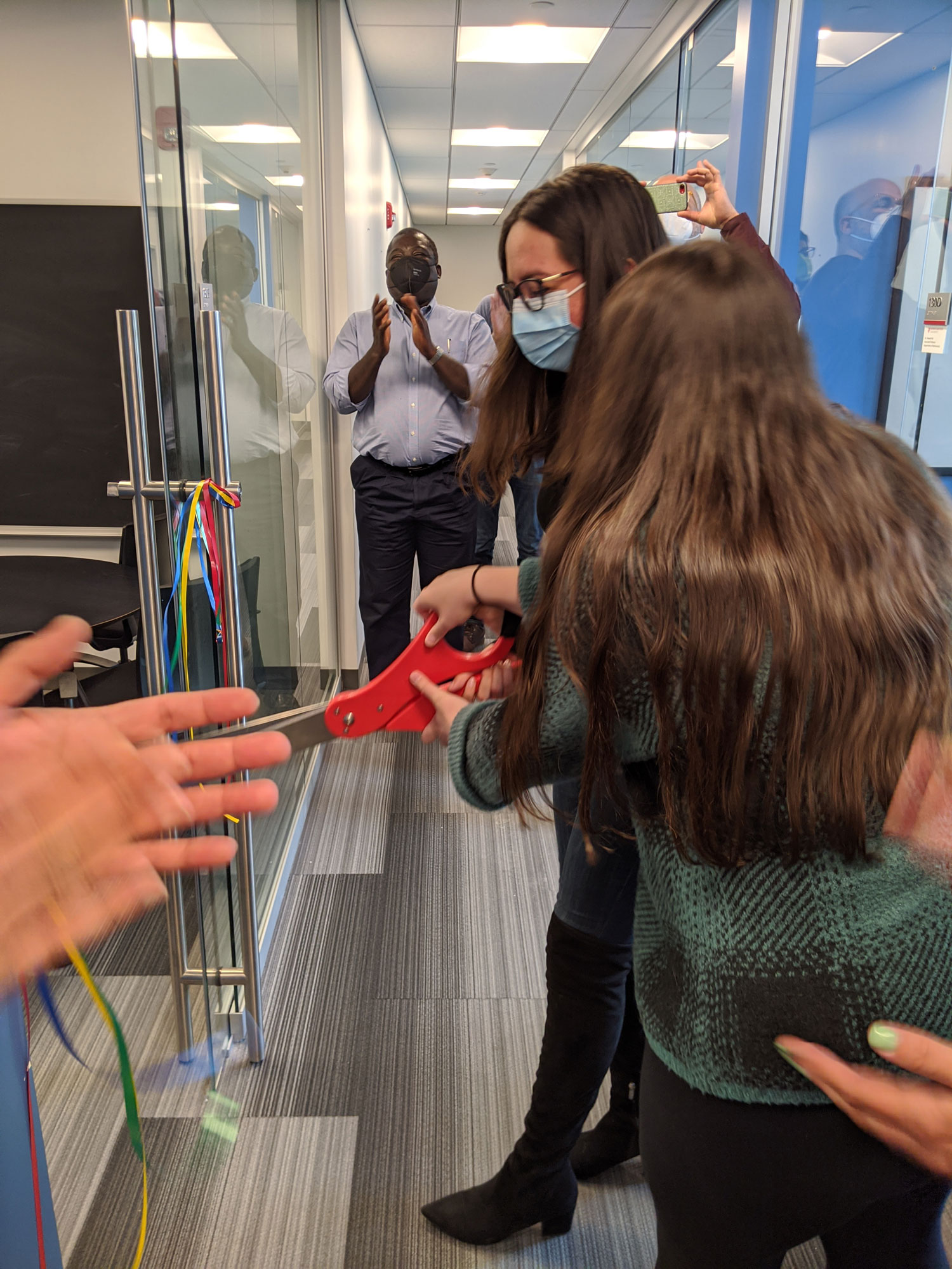 cutting the ribbon with big scissors