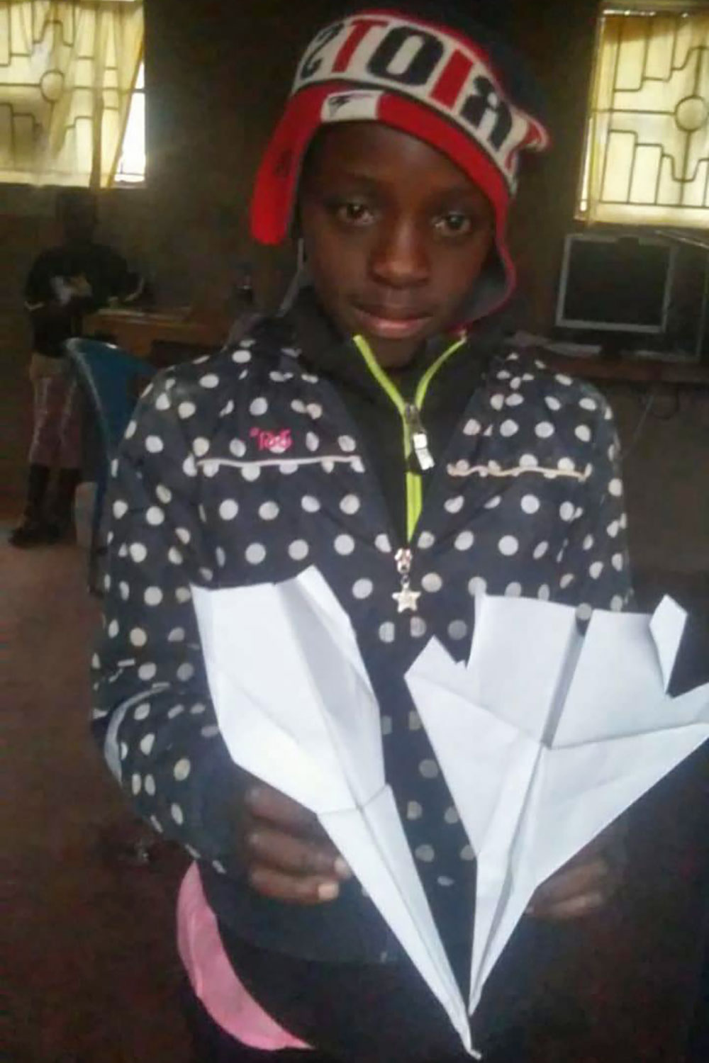 STEM Center Africa student with paper airplanes