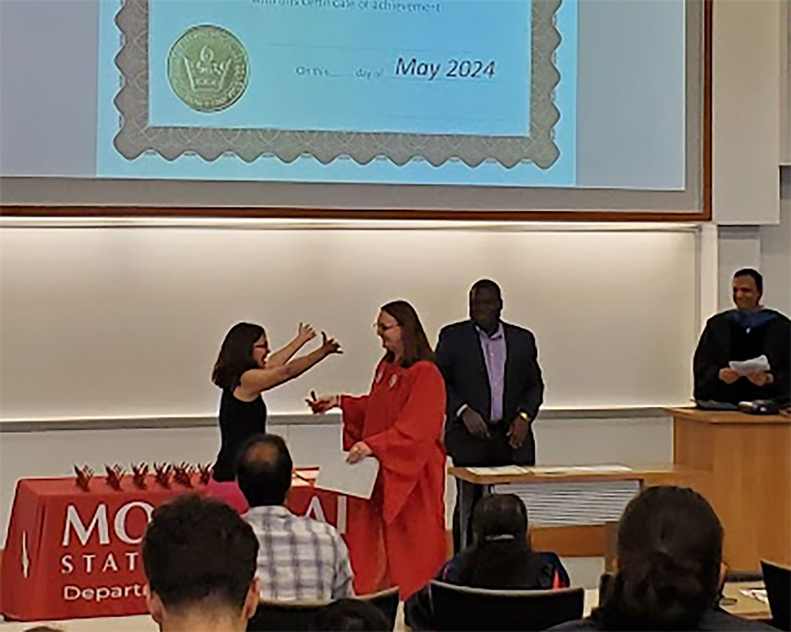 Fernandez congratulating student