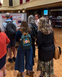 Alic talking with attendees about poster at USCOTS 2025