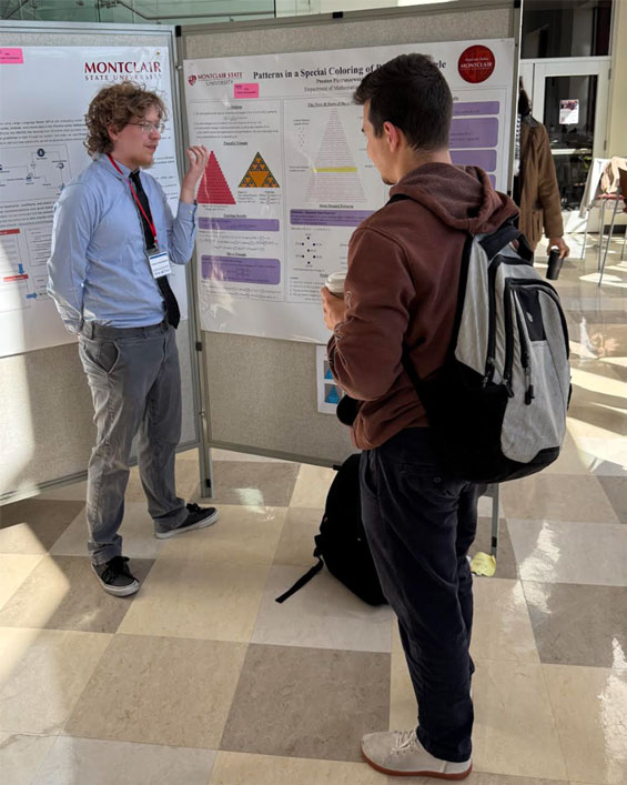 Preston Pietruszewski discussing his poster with attendees