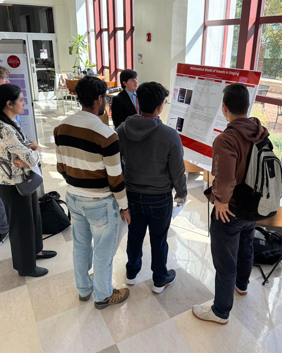 Ryan Avallone discussing his poster with attendees