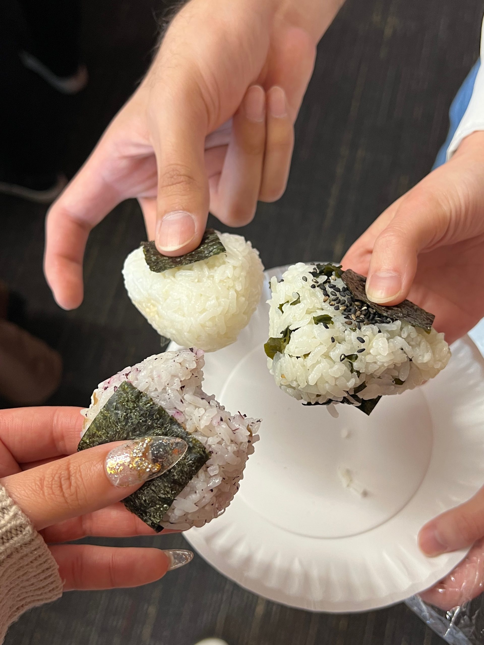 Photo of students showing off onigiri