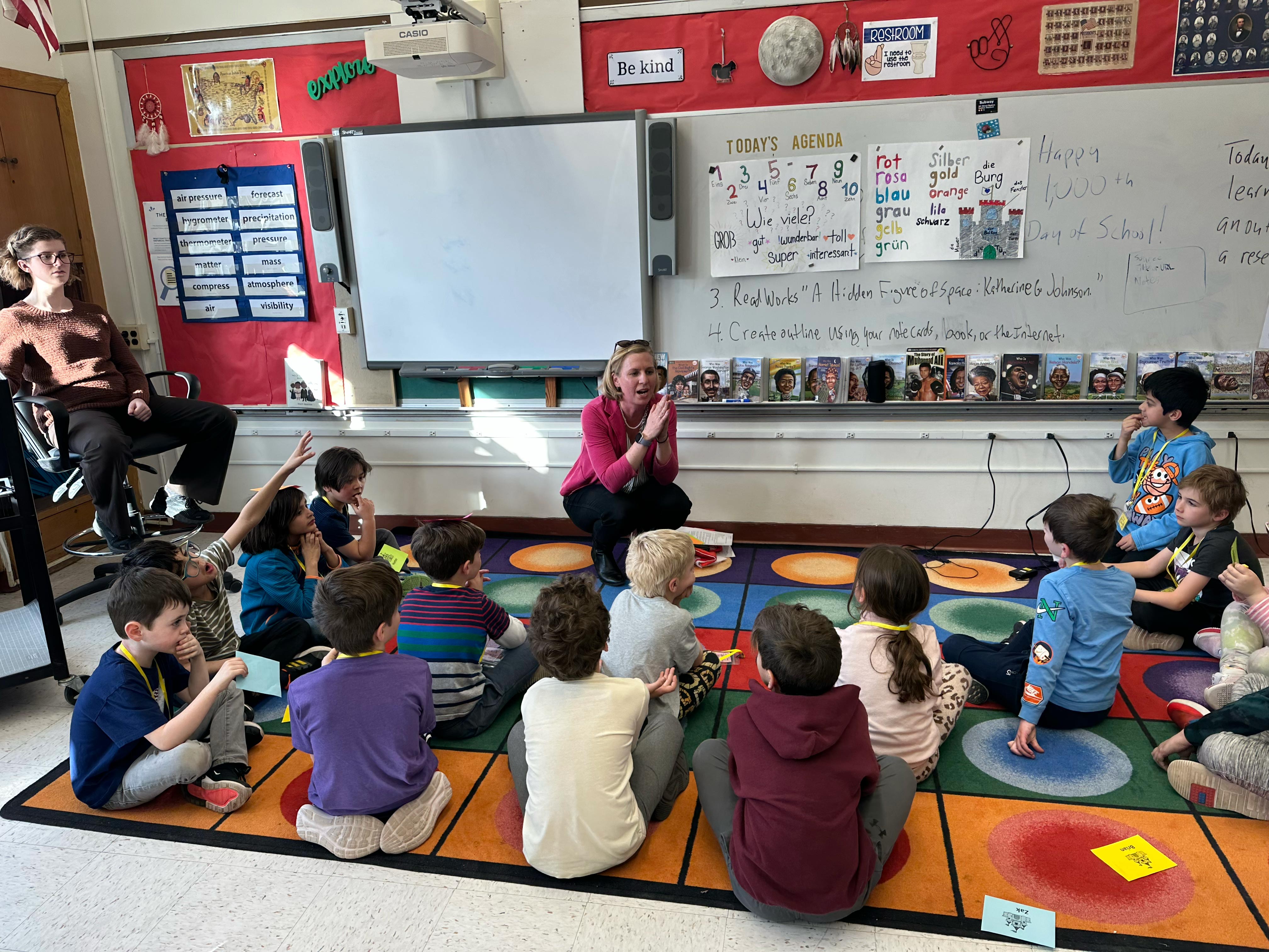 Professor Pascale LaFountaine at front of classroom with elementary students seated in front of her