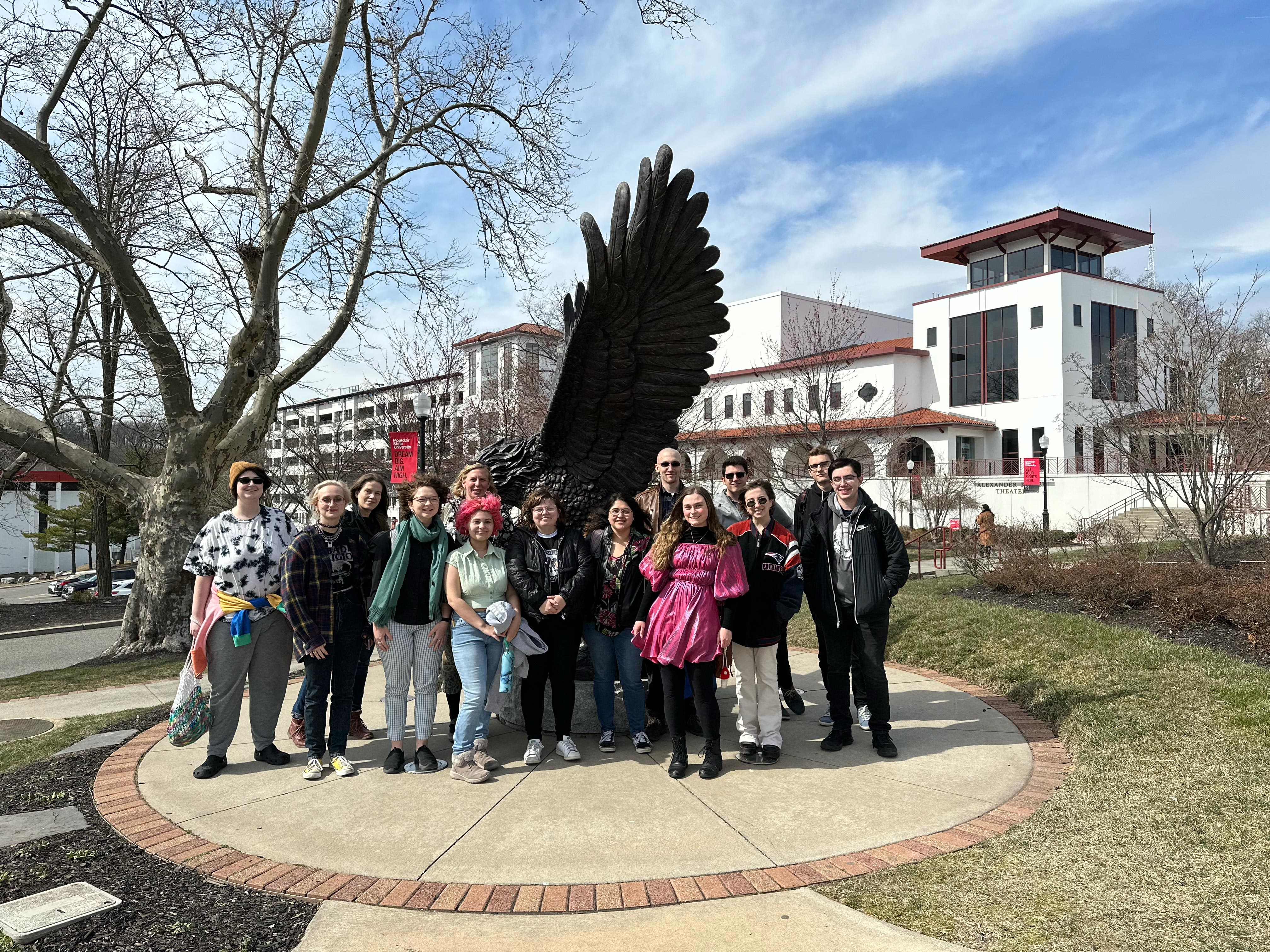 students in German SPARK Lab standing in front of red hawk statue