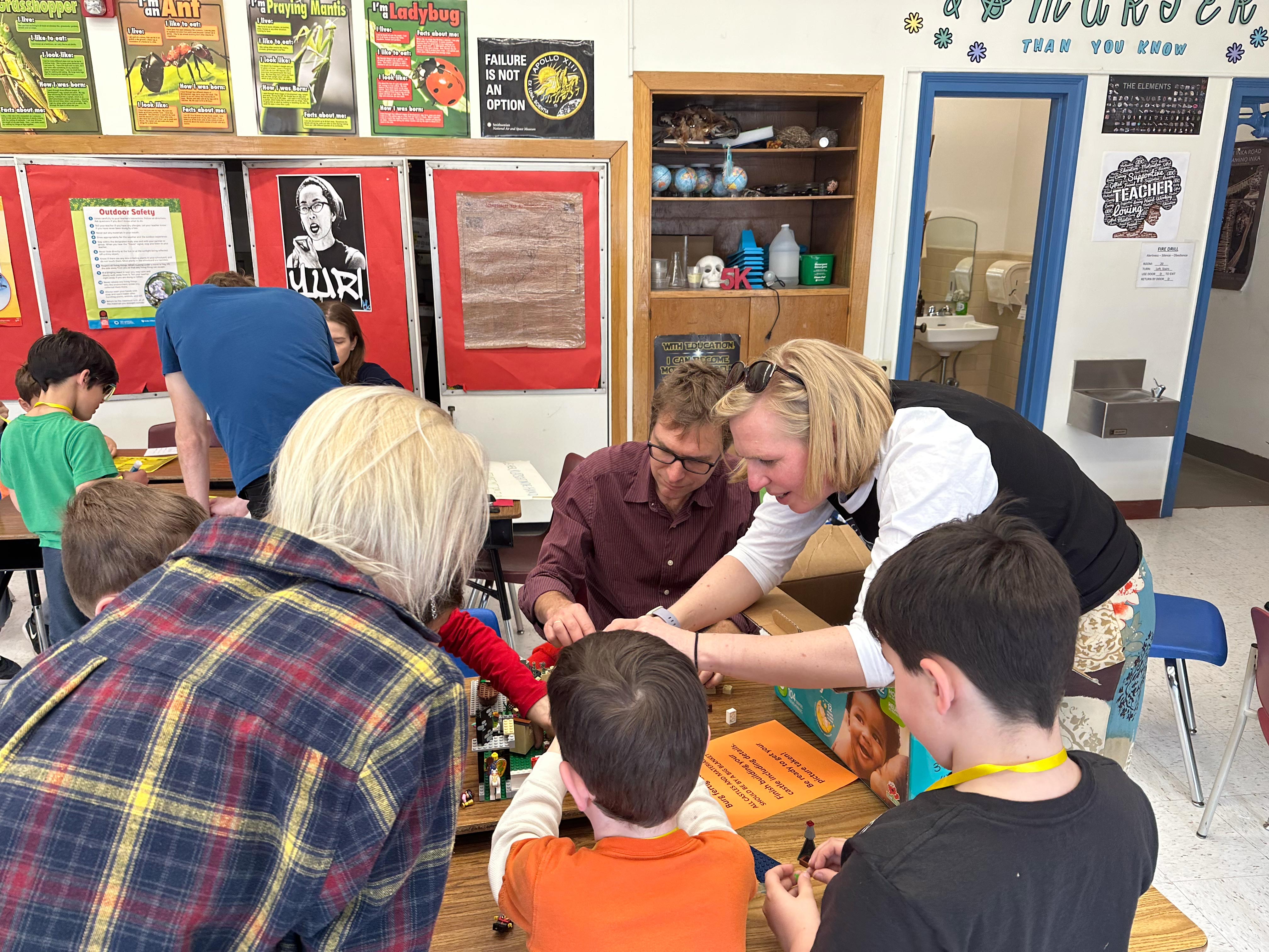 Professors Herold and LaFountain work building legos with young students