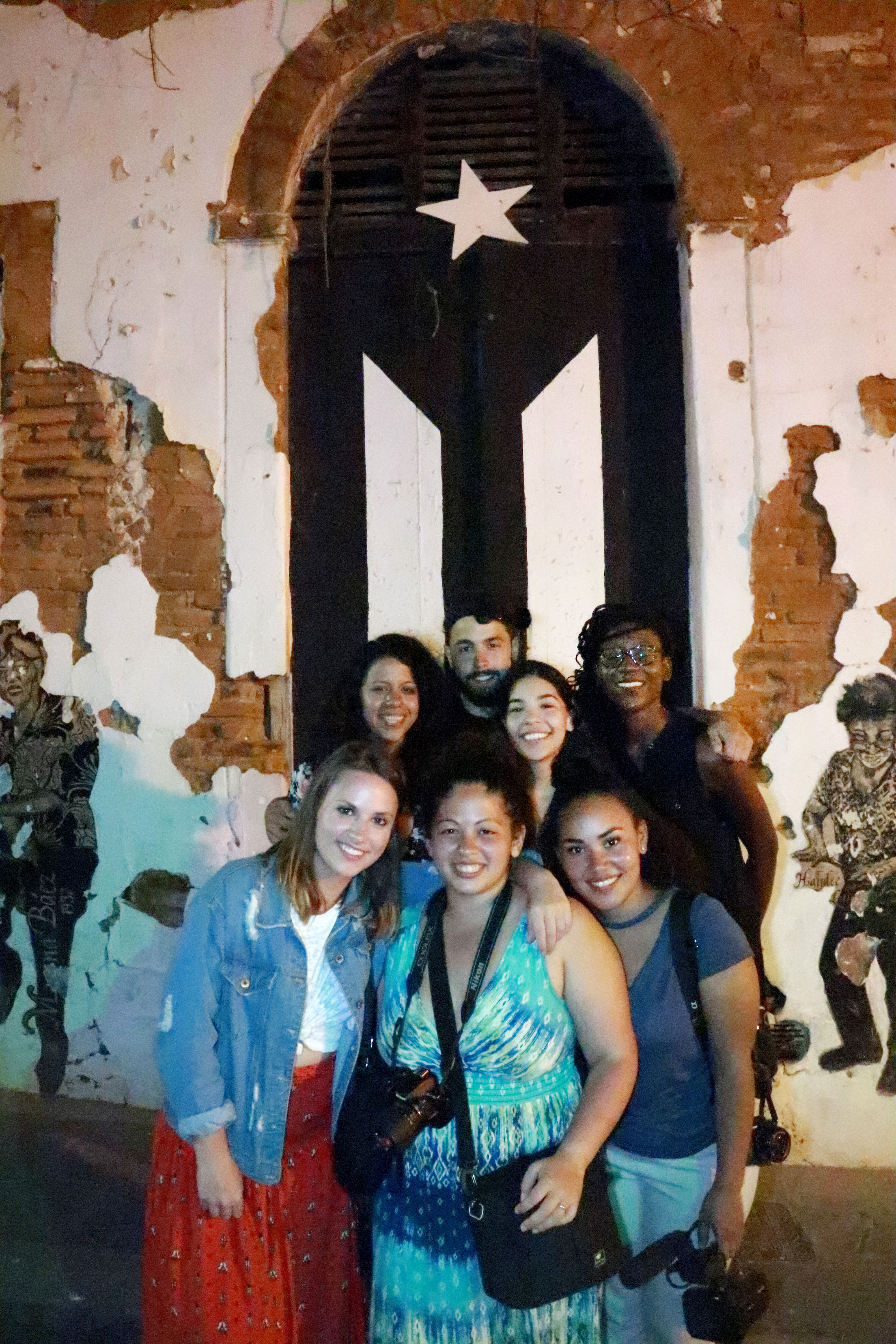 Students in Puerto Rico in front of decrepit building