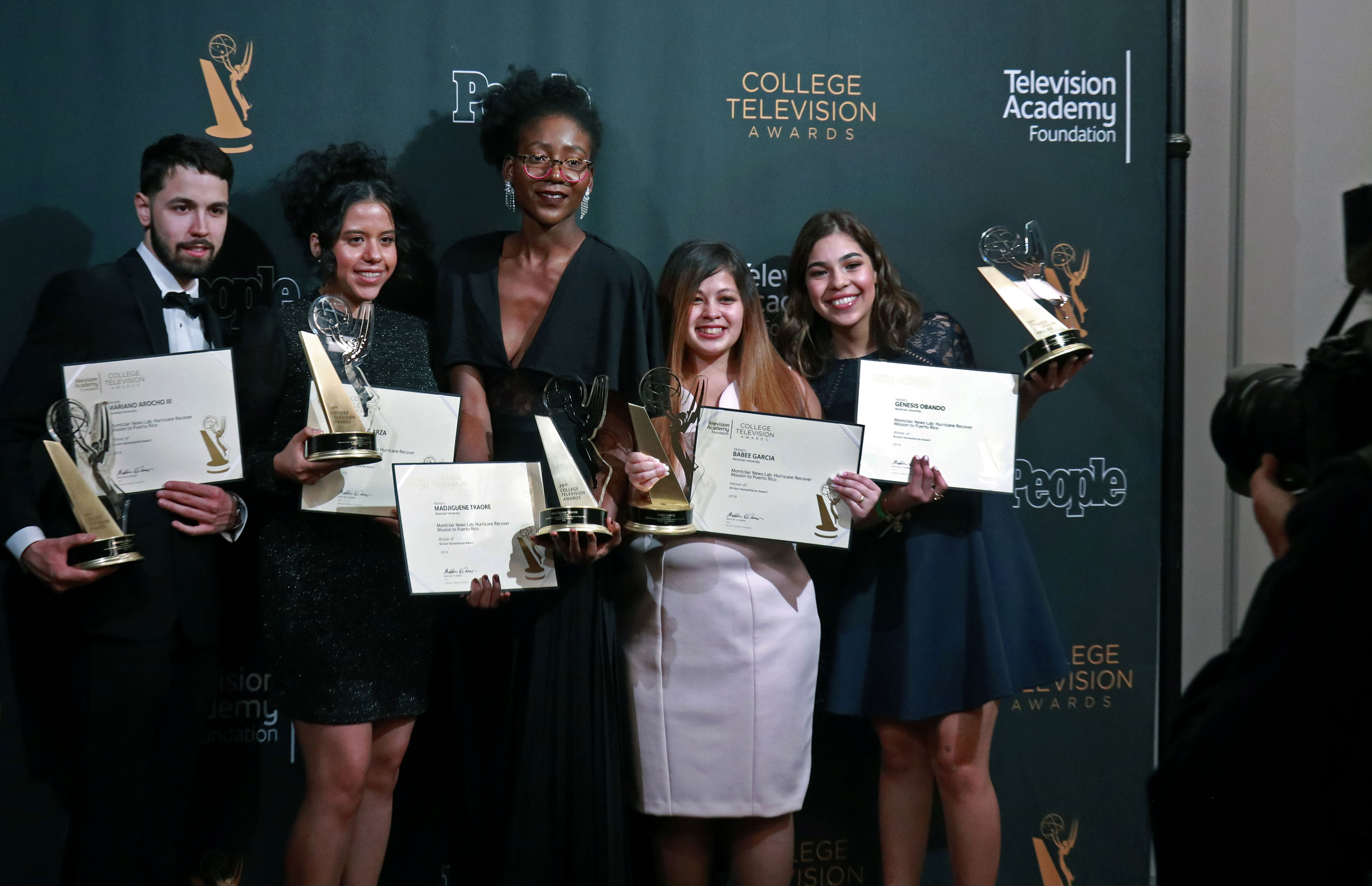 Students holding up awards at College Emmys