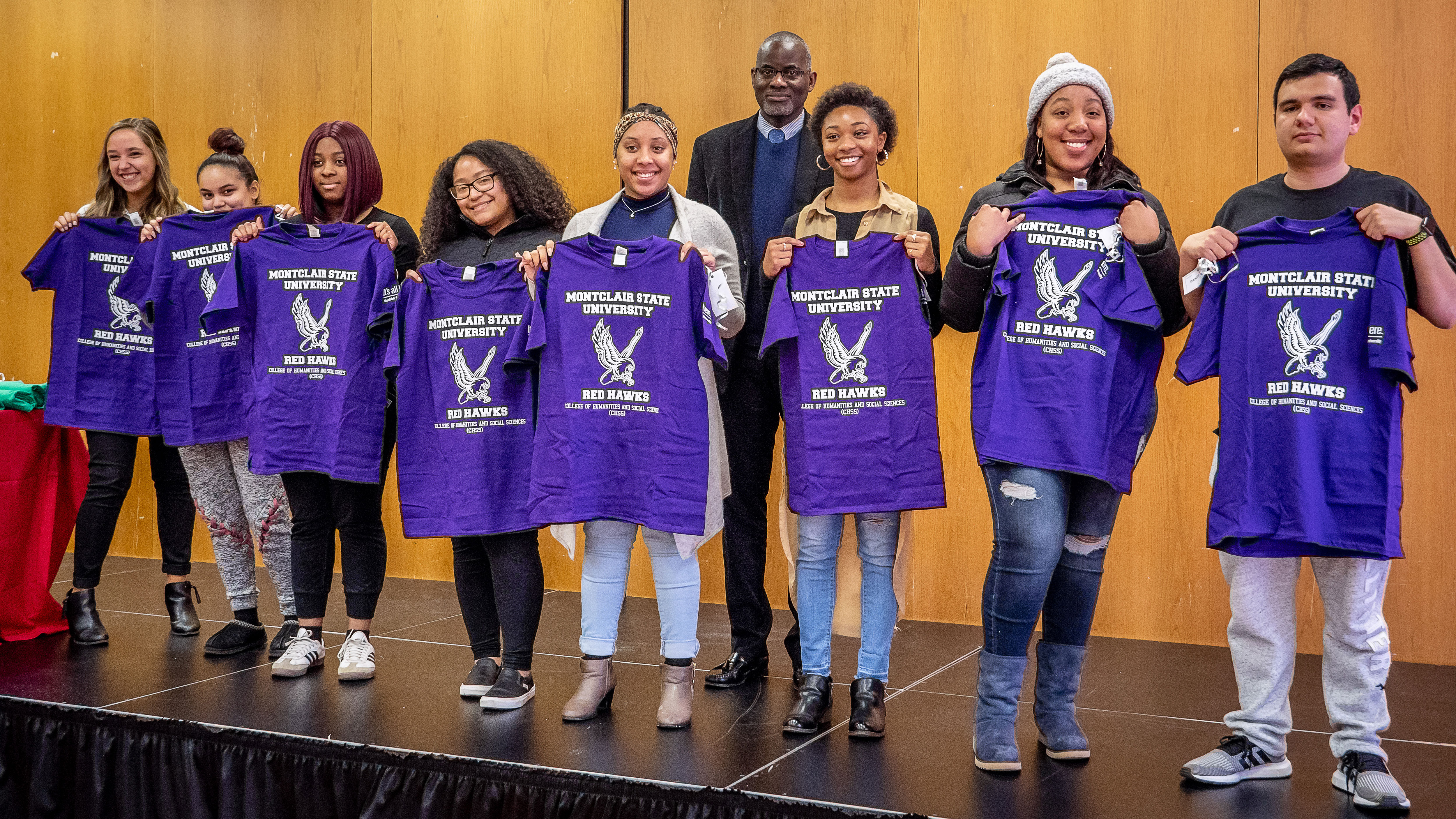 CSAM students holding purple shirts