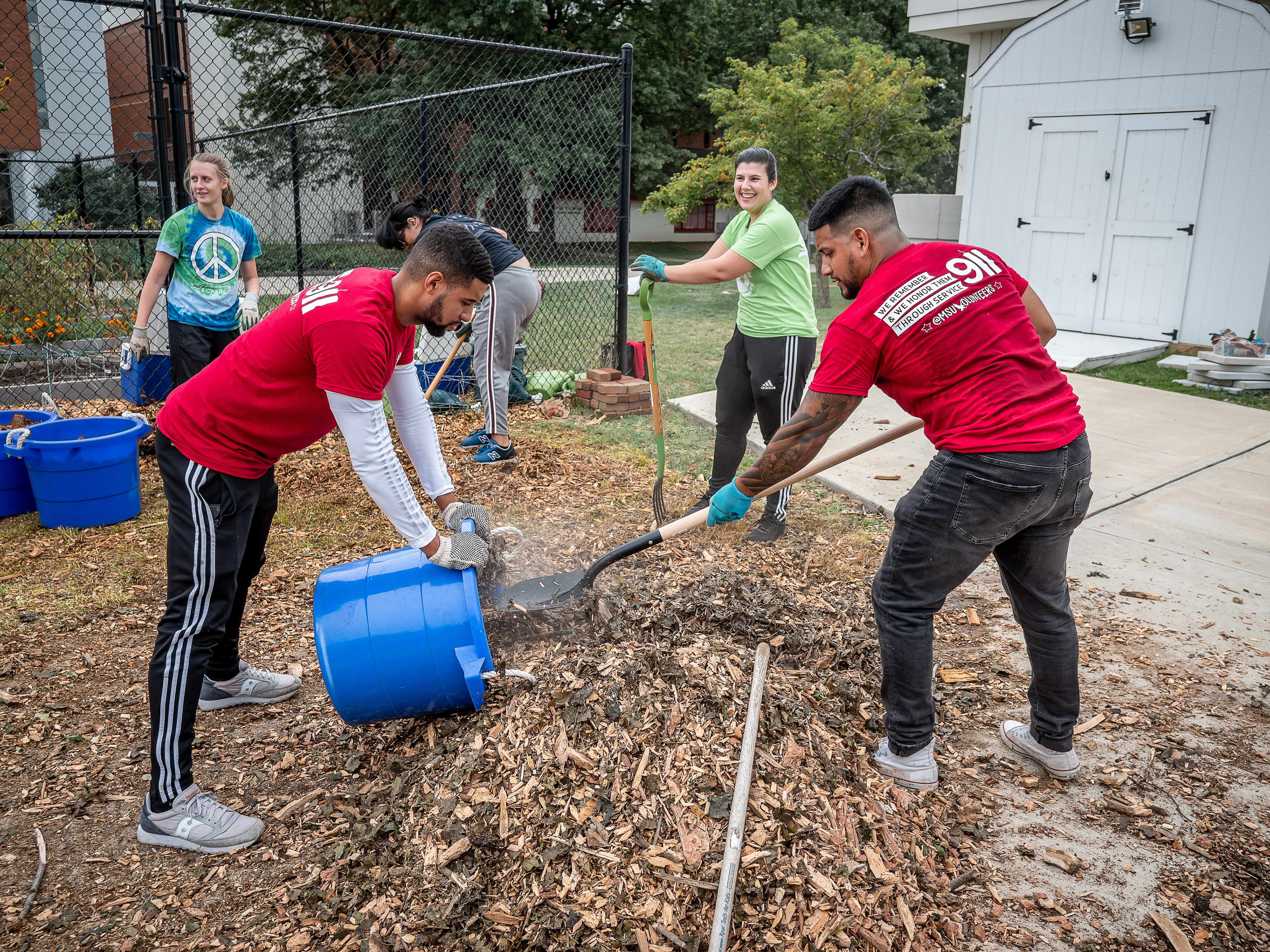 At the Montclair State Campus Community Garden, students assist with the cleanup.