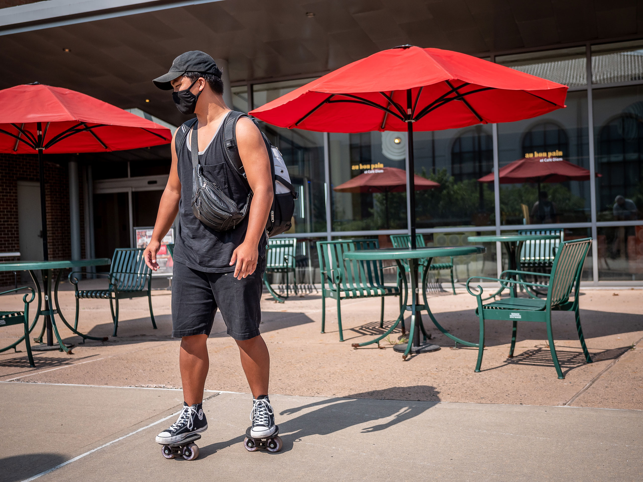 Student rolling by on split skateboard