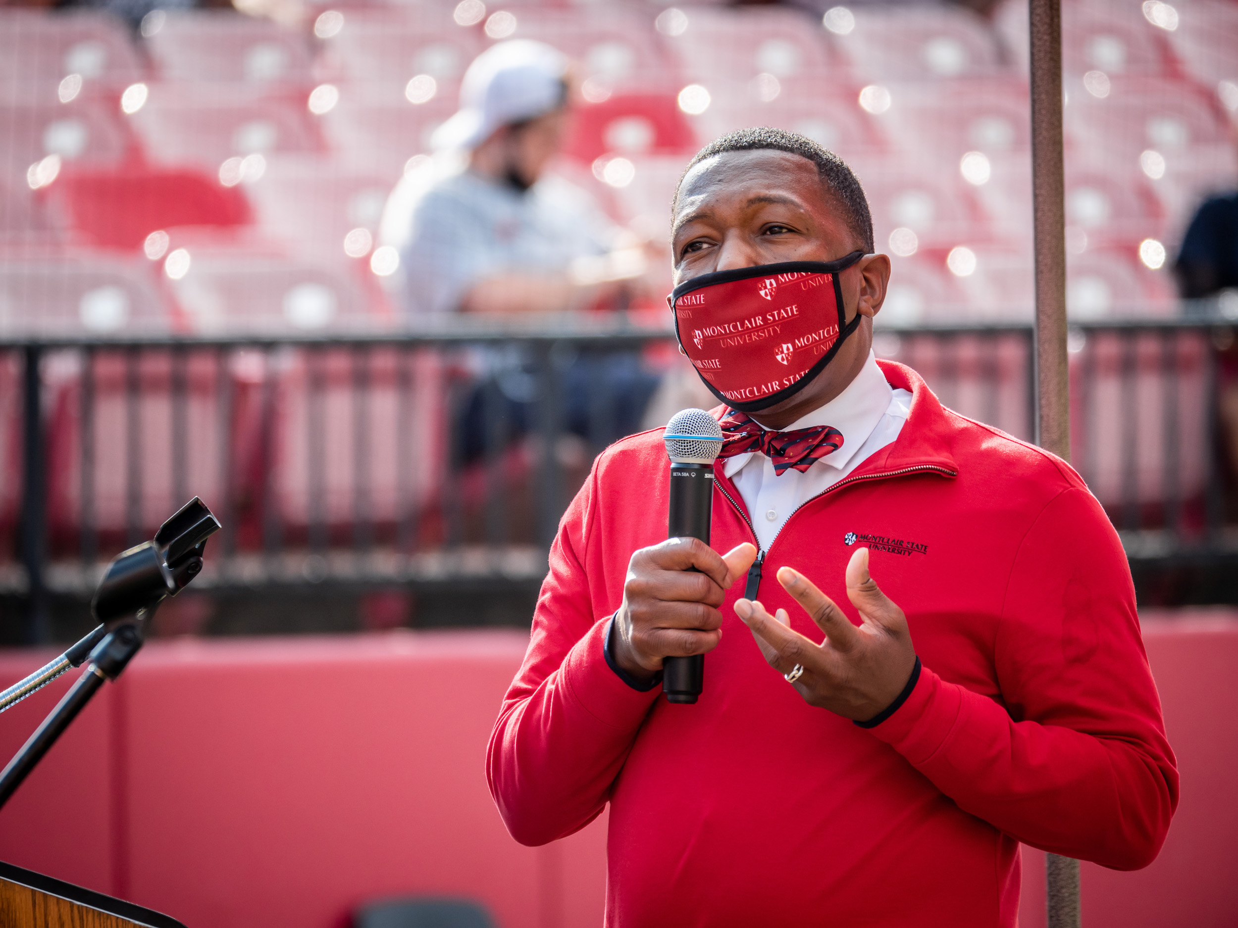 Photo of David Hood, Associate Provost for Undergraduate Education at Montclair State University in a red sweater and red mask