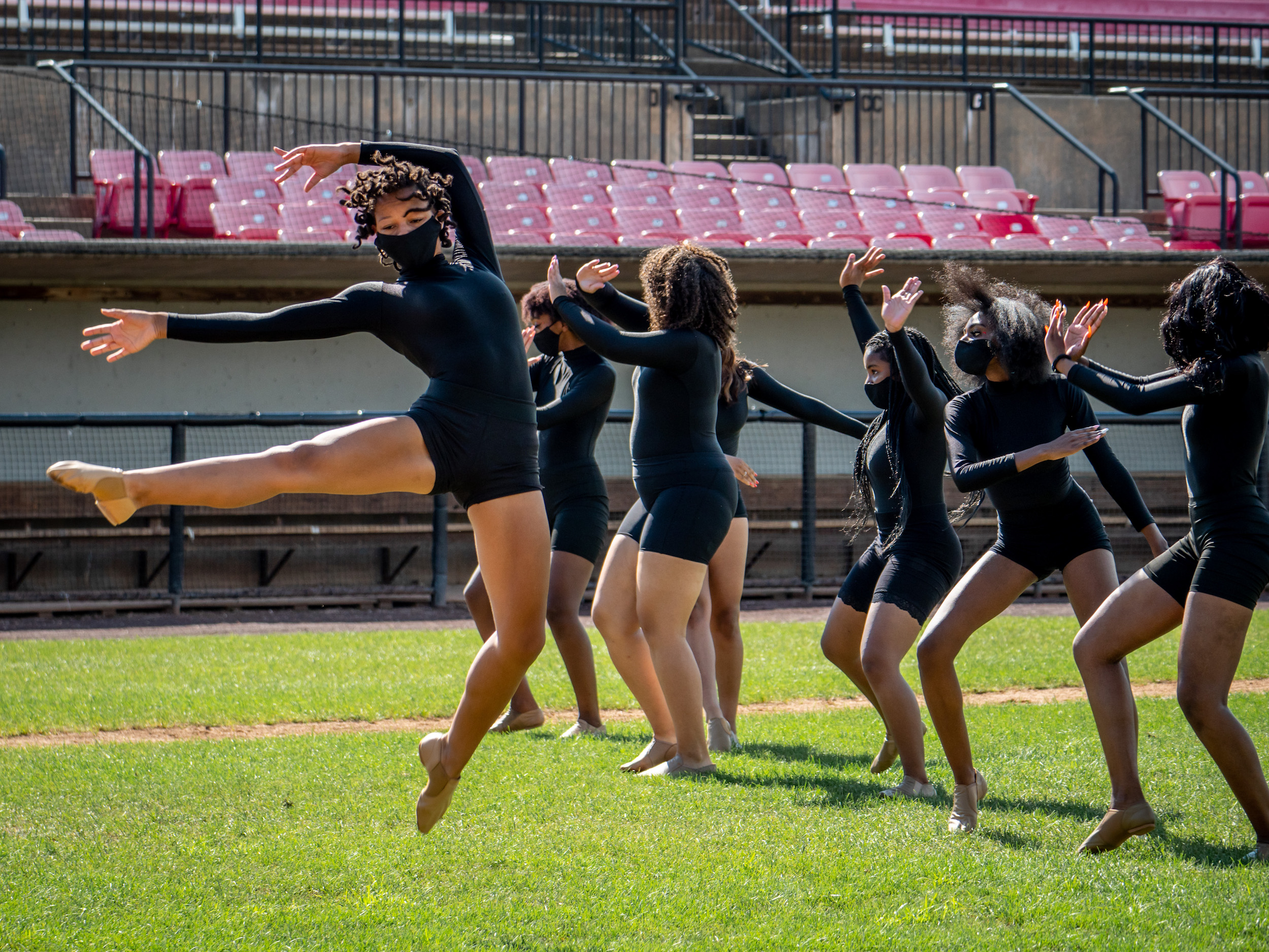 Photo of The Complexions Band Dance Team performing on a football field