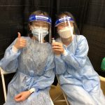 Photo of Jiwon Woo and Danica Arcena volunteering at the Essex County vaccination site.