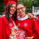 Two graduates in red gowns