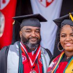 older man and younger woman in matching caps and gowns